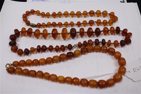 Five assorted amber necklaces.